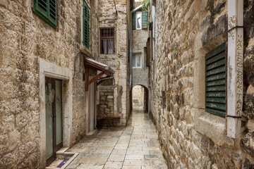 Narrow and empty alley or pedestrian street at the Old Town in Split, Croatia.