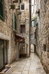 Narrow and empty alley or pedestrian street at the Old Town in Split, Croatia.