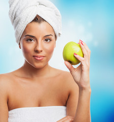 portrait of a young woman eating an apple after taking a bath