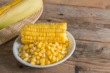Boiled corn in white dish on the table.