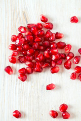 pomegranate seeds on wooden surface