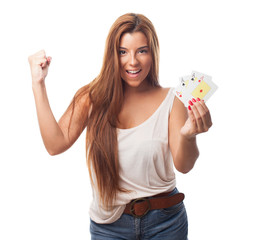 Obraz premium portrait of a young woman playing poker and doing a winner gestu