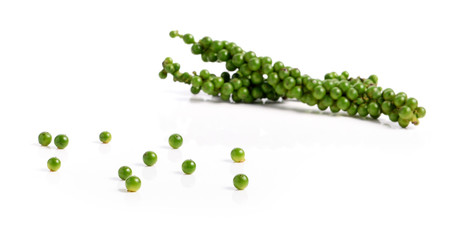 green peppercorns on white background