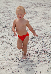 cute boy having fun on beach