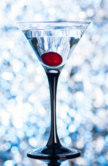 Cocktail in martini glass on the bokeh background