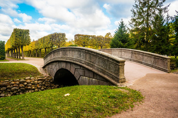Arch bridge and fish channel in catherine park in autumn