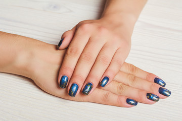 Obraz na płótnie Canvas Dark blue nail art with gold stars