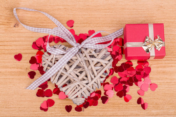 Red hearts confetti on wooden background