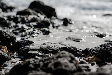 Rocky coast of Tenerife. Black volcanic stones. Canary Islands.