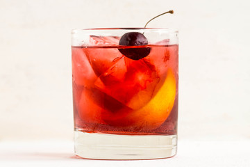 Old fashioned cocktail on white wooden background