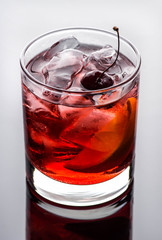 Old fashioned cocktail on white wooden background
