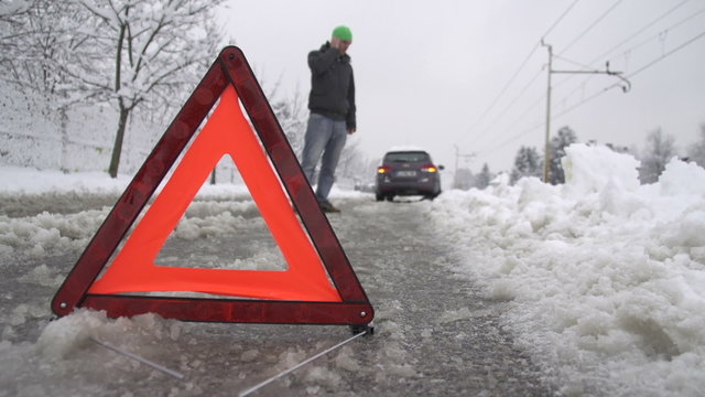 Man calling car towing service for help