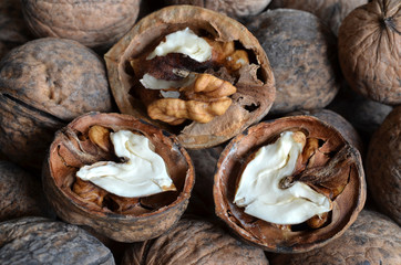 core walnut in the form of heart on the background of walnuts in shell  
