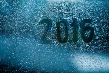 New year abstract card. written on a frozen glass window. macro view