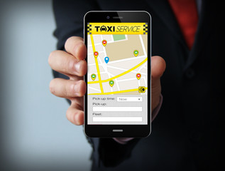 Businessman with taxi app on phone