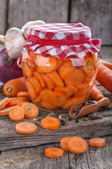 canned fresh domestic carrot in a jar on an old rustic table