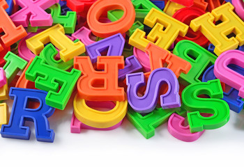 Colorful plastic alphabet letters on a white
