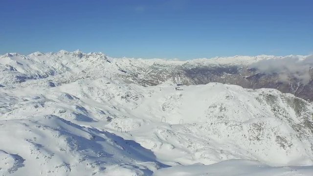 AERIAL: Ski lift in the mountains 