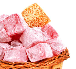 Turkish sweet delights in icing sugar in the basket isolated on
