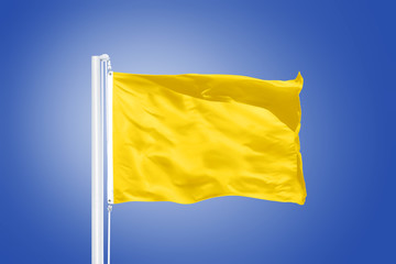 Yellow flag flying against clear blue sky