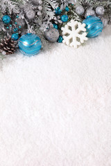 Christmas border with decorations on the snow and copy space