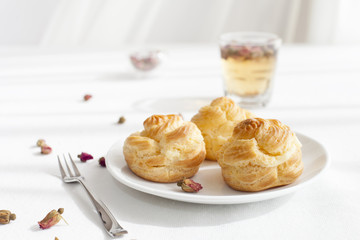 Profiteroles, choux with custard and anglaise, whipped cream, dessert 