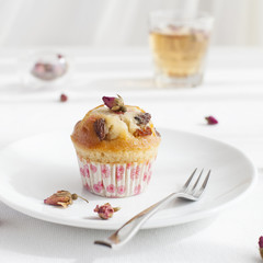 Muffin, mini cake, cupcake  with a rose buds tea 