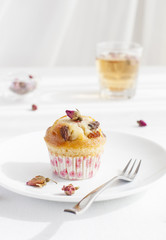 Muffin, mini cake, cupcake  with a rose buds tea 