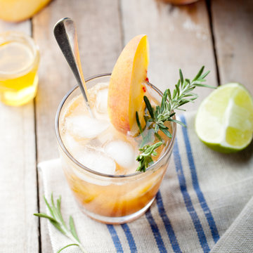 Peach and rosemary fizz cocktail on a wooden background. Cocktail.