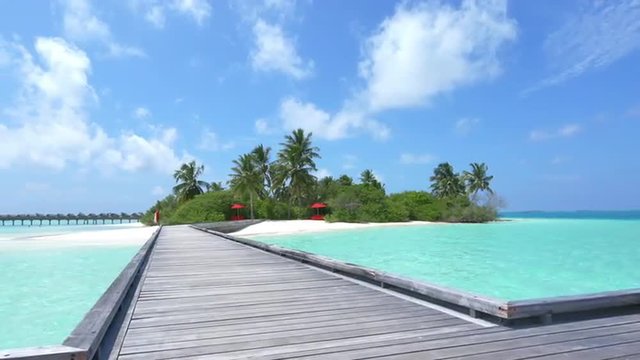 Wooden jetty and water villas in exotic island of Maldives