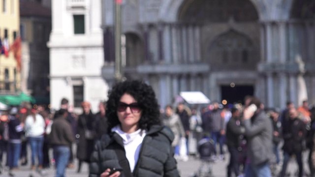 Woman tourist takes smartphone selfie at Square 
