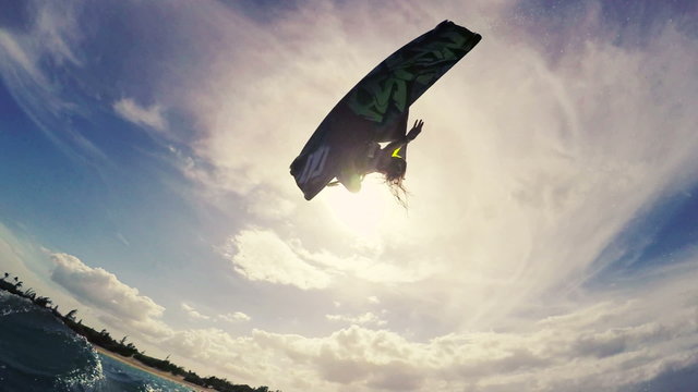 Slow Motion Girl Catches Air Kiteboarding. Fun in the ocean, Extreme Sport Kitesurfing.