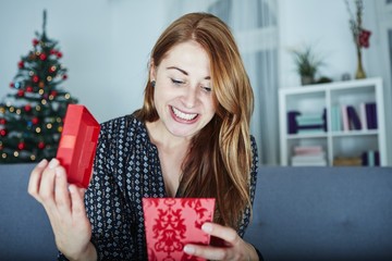 young happy girl opens christmas gift
