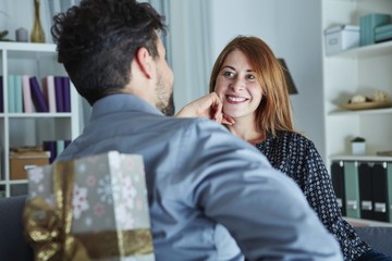 young man surprise girlfriend with gift