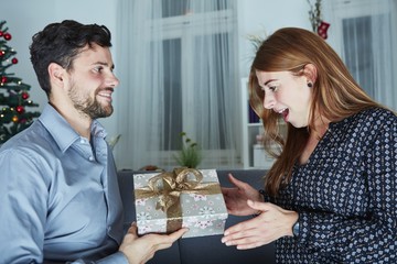 young man give her girlfriend a present box