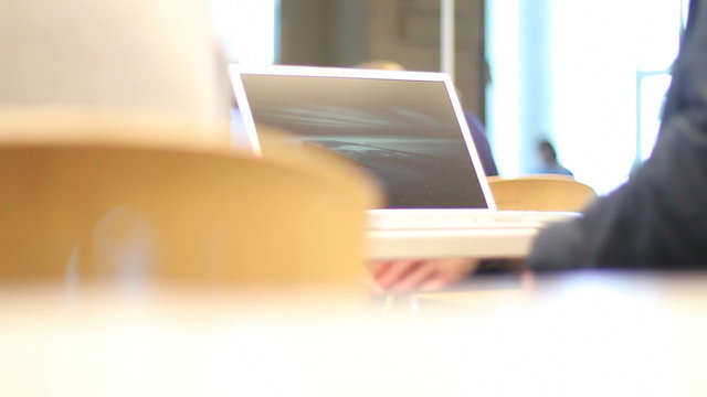Students closes laptop in a library