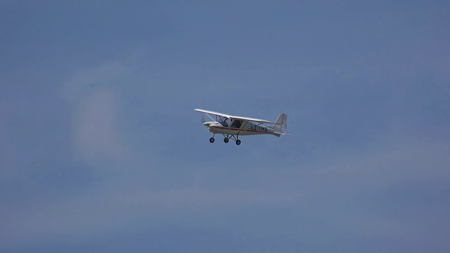 Small grey airplane with propeller engines flying 