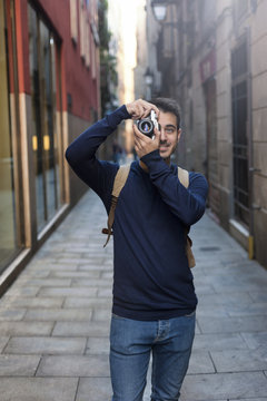 Young man taking photos in Barcelona