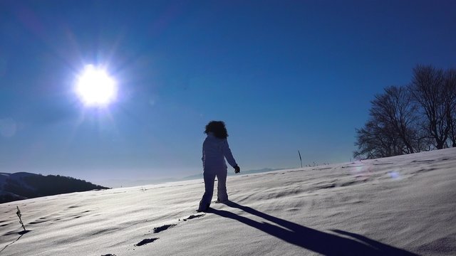 hiker woman walking in the snow. expedition 