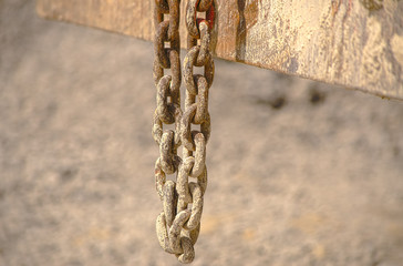 HDR old chain hangs on a excavator in a concrete plant
