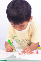 a little asian boy paint color on white paper on white backgroun
