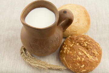 clay jug with milk and bread