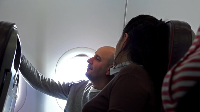 Zoom to happy couple travelling by plane 