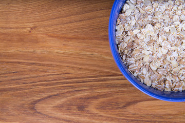 oat flakes in a blue plate on a dark wood