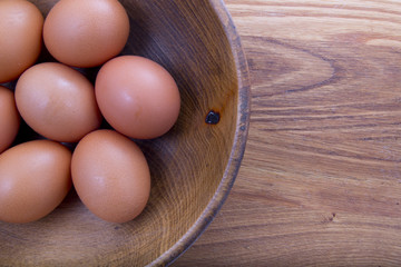 brown eggs in a wooden plate