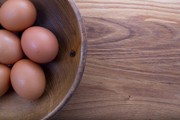 brown eggs in a wooden plate