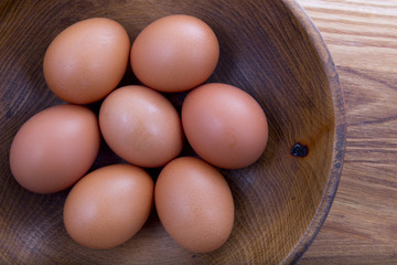 brown eggs in a wooden plate