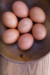 brown eggs in a wooden plate