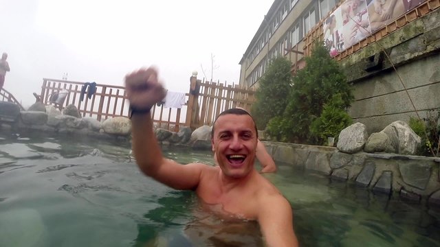 Man show victory pose in spa pool