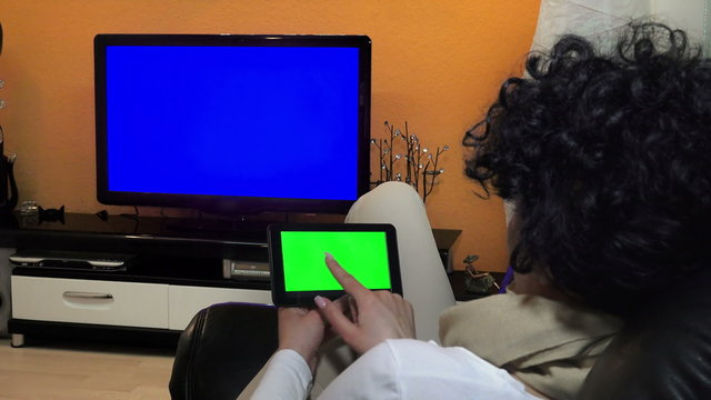 woman watches television while holding a and 